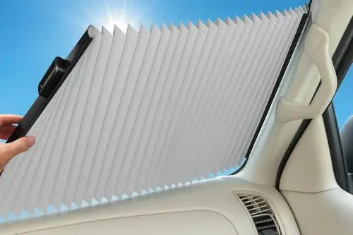 Dash Designs silver retractable car sun shade deployed on a windshield