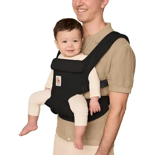 Ergobaby Omni Classic structured baby carrier in pure black, shown being worn in a front inward carry position.