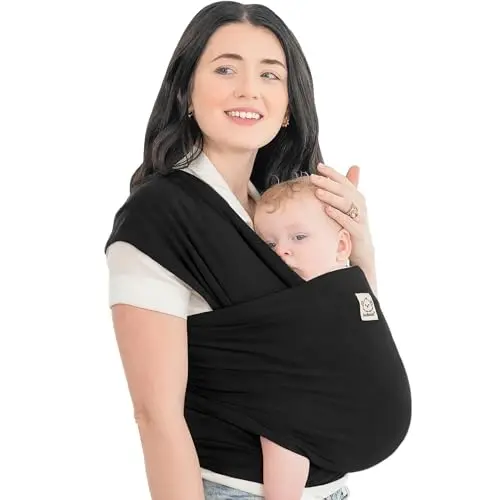 KeaBabies stretchy baby wrap carrier in trendy black, wrapped snugly around a parent's torso holding an infant.
