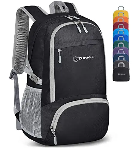 ZOMAKE black lightweight foldable backpack sitting on grass, showing its 30L capacity and multiple compartments.