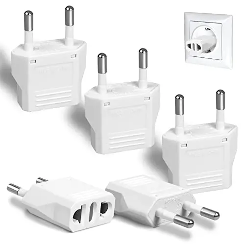 Six small white European Type C plug adapters on a table