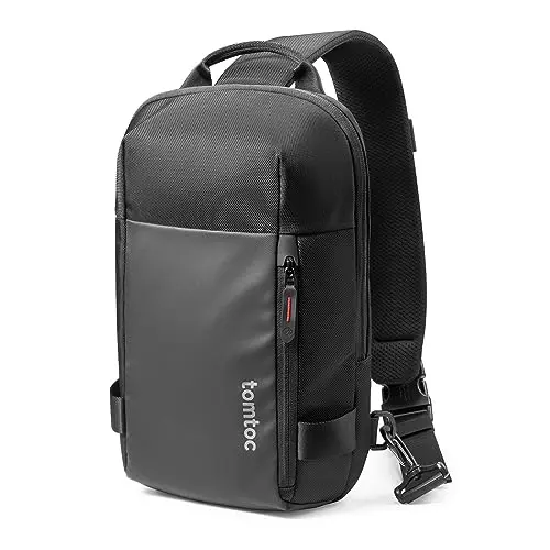Tomtoc compact black sling backpack worn crossbody, showing sleek vertical design