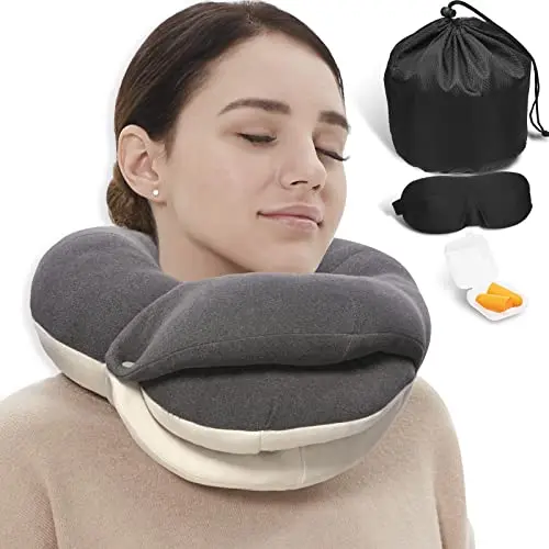 BUYUE travel neck pillow in grey with a 3D eye mask and earplugs, showing its Q-shaped design.