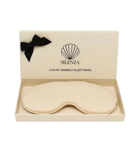 Silenza ivory bamboo silk sleep mask on a bed